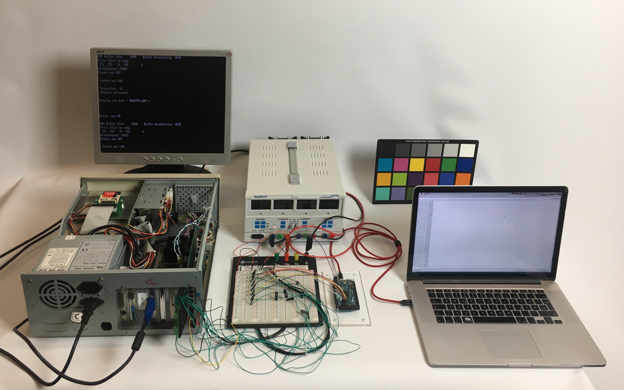 A computer and electronic tools on a table.